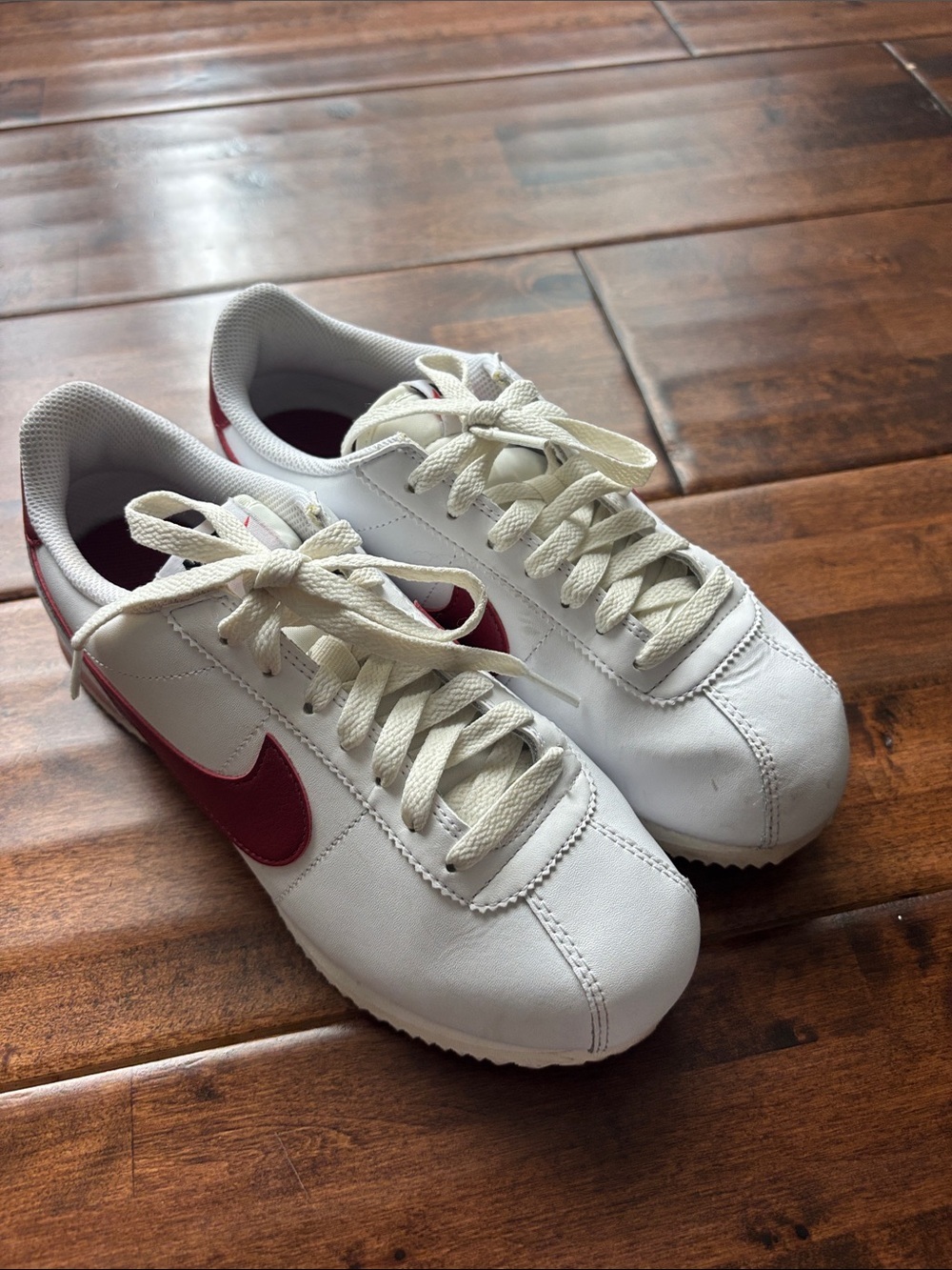 Nike White Sneakers with Red Swoosh Accent